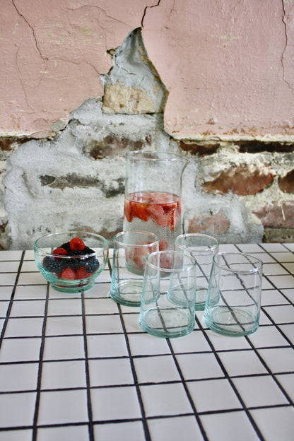 Set of 24 handblown glasses handmade in Morocco from recycled glass by artisans using traditional techniques since 1946.